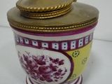 a vase with a lid on a white table