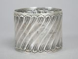 a close up of a silver bracelet on a white surface