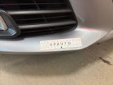 a close up of a car ' s grille with a sticker on it