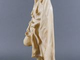 an old statue of a man with a hat and cloak