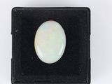 a white oplite stone in a black box on a white background