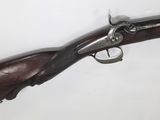 an old gun with a wooden handle on a white background