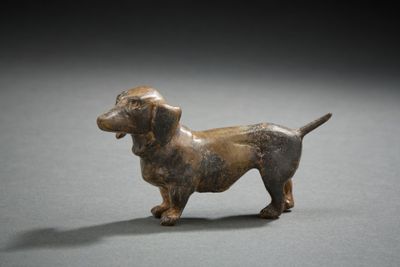 figurine of a dachshund dog on a gray surface