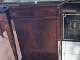 a wooden desk with a black top in a room