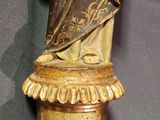 a statue of a woman holding a bird on top of a pedestal