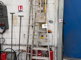 a ladder leaning against a wall next to a fire hydrant