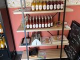many jars of honey on the shelves in the store