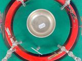 a picture of a red and green plate with a silver plate in the middle