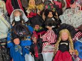 a lot of dolls that are sitting together on a table