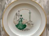 a plate with a picture of a woman in a green dress