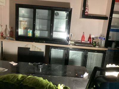 une cuisine avec un plan de travail noir et un réfrigérateur noir