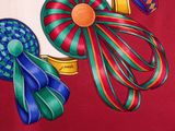 a picture of a red shirt with a bunch of ribbons on it