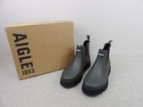 une paire de bottes de pluie noires posée sur une boîte en carton