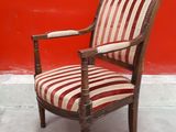 a chair that is sitting in front of a red wall