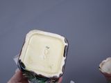 a person holding a container of food in their hand