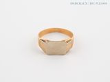 a close up of a gold ring on a white surface