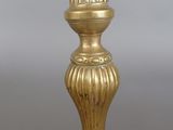 pair of antique brass candlesticks on a grey background