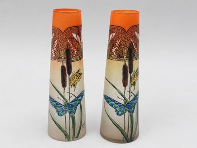 two vases that are sitting on a white surface
