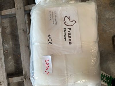 a bag of pillows on a pallet next to a pair of scissors