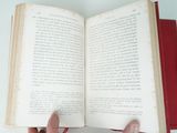 a person holding an open book in their hands