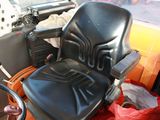 a black seat on the back of a tractor