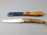 two knives that are sitting next to each other on a table