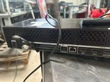 an image of a laptop with a remote on top of it