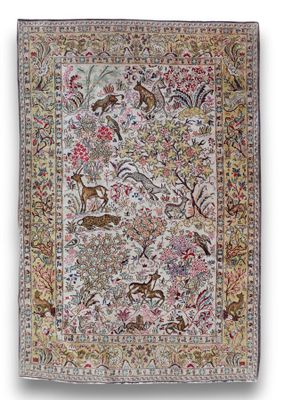 an antique persian rug with birds and flowers