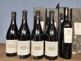 several bottles of wine are lined up on a table