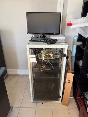 a computer on top of a glass cabinet in a room