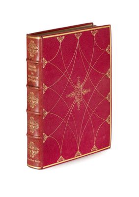 an old red book with gold trim and a cross on the cover