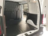 a white van with the door open in a garage