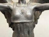 a statue of a woman with wings on a pedestal