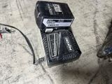two batteries that are sitting on the floor next to a motorcycle