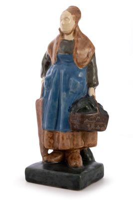 figurine of a woman sitting on a chair holding a suitcase