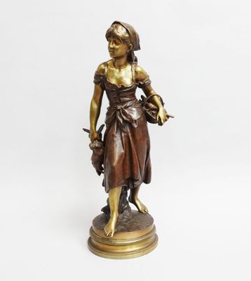 bronze statue of a woman holding a basket of flowers
