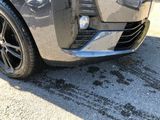 a close up of a car ' s front bumper with mud on it