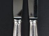 two knives that are sitting next to each other on a table