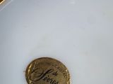a close up of a gold plate with a label on it