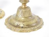 pair of antique brass candlesticks on a white background
