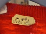 a close up of a red jacket with a label on it