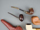 several different types of smoking pipes are lined up on a table