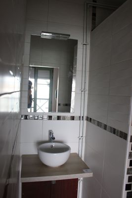 a bathroom with a sink and a mirror in it