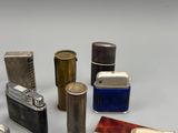 a lot of lighters that are sitting on a table