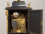a black and gold clock sitting on a wooden table