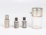 three salt and pepper shakers sitting next to each other