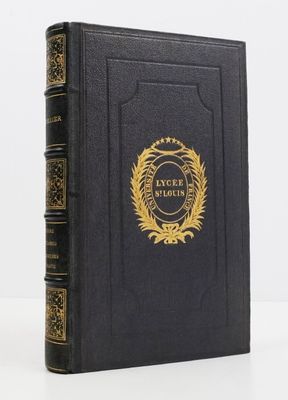 un livre noir orné d'un emblème doré sur la couverture