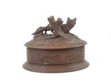 a bronze statue of two dogs sitting on top of a box