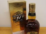 bottle of chivas regal xxv next to box on wooden table