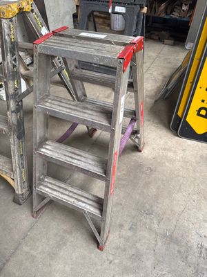 two ladders sitting next to each other in a garage
